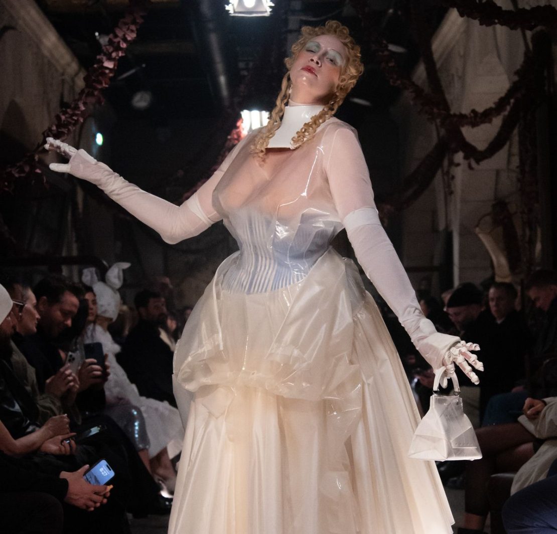 Perhaps the most show-stopping moment of all, however, was the appearance of the actress Gwendoline Christie, who took to the runway to close the show in a sheer, corseted gown overlaid with tinted rubber that wouldn't have looked out of place in a Tim Burton film. The look was accessorised with white stockings, heels and bag, as well as doll-like make-up with a gothic slant: think exaggerated blonde curls, glassy skin and smudged eyeshadow.