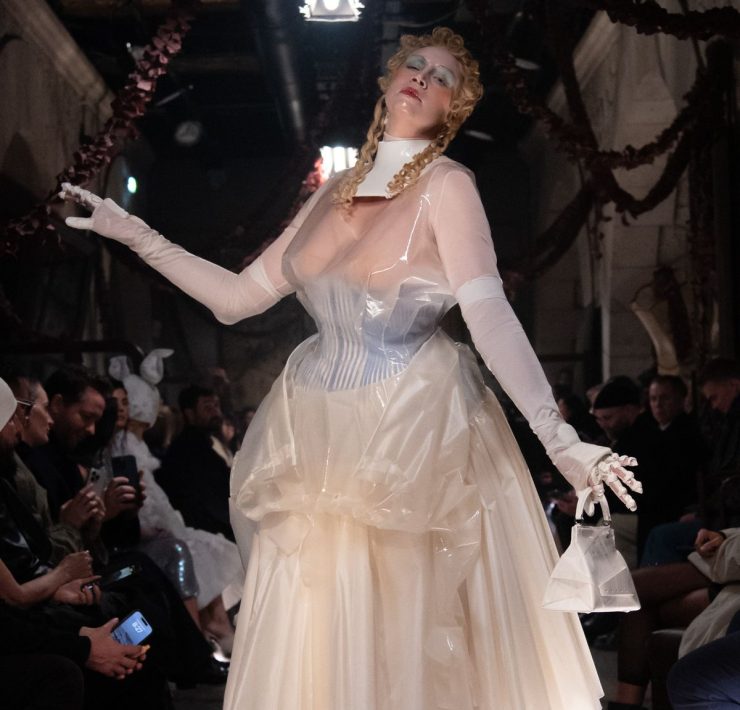 Perhaps the most show-stopping moment of all, however, was the appearance of the actress Gwendoline Christie, who took to the runway to close the show in a sheer, corseted gown overlaid with tinted rubber that wouldn't have looked out of place in a Tim Burton film. The look was accessorised with white stockings, heels and bag, as well as doll-like make-up with a gothic slant: think exaggerated blonde curls, glassy skin and smudged eyeshadow.
